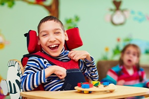 Laughing child in a wheelchair
