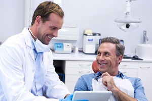 Dentist and patient discussing need for tooth-colored fillings
