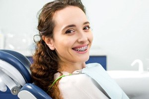 Smiling dental patient with braces