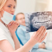 Dental team member looking at patient’s X-ray