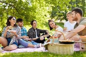 Group of young adult friends eating at a picnic