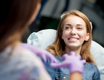 Smiling young woman in dental chair