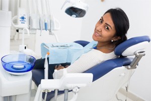 Happy dental patient looking over her shoulder 