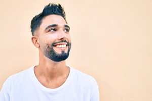 Man in white shirt enjoying benefits of CEREC dental crowns