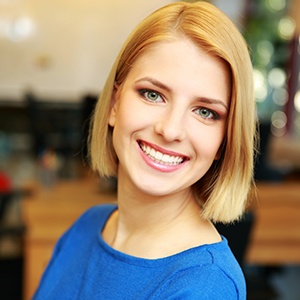 Woman smiling after dental crown restoration