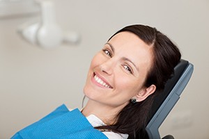 Happy patient at appointment to receive dental bridge