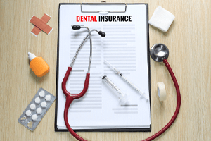 Dental insurance form next to medical instruments