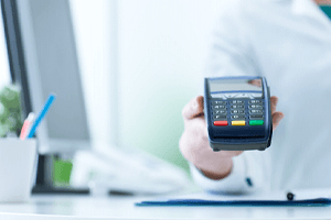 Woman holding machine for reading payment cards