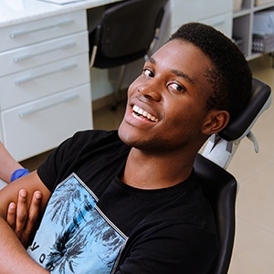 Smiling man at dental office for tooth extractions