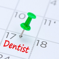 Dental appointment marked by green thumbtack on calendar