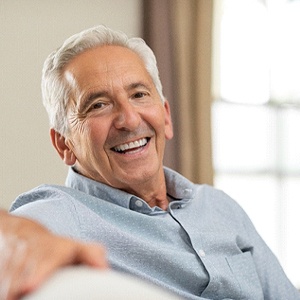 Happy senior man with implant dentures in Northborough