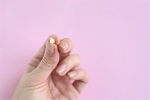 Woman’s hand holding extracted tooth
