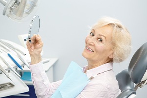 Woman smiling after full mouth reconstruction