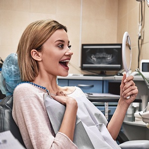 Patient admiring her smile after smile makeover process