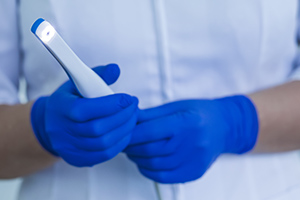 Dentist holding intraoral camera