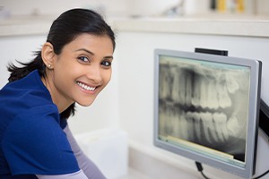 Dental team member looking at digital x-rays on computer