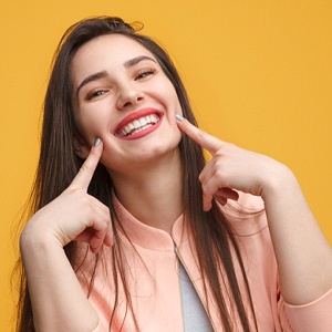 Woman showing beautiful smile after receiving tooth-colored fillings in Northborough