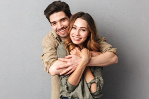 Happy young couple enjoying benefits of tooth-colored fillings