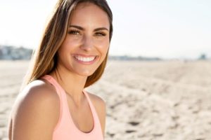 Woman with beautiful teeth smiling on beach