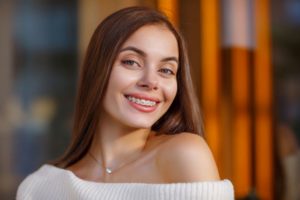 Confident, smiling young woman with braces