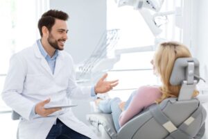 Dentist and patient having friendly conversation