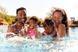 Happy family playing in a pool