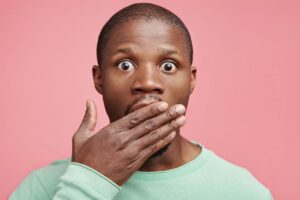 Concerned man covering his mouth