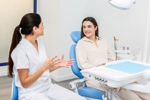 Dentist and patient engaged in friendly conversation 